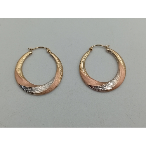 374 - A pair of stamped 9k gold hoop earrings.
