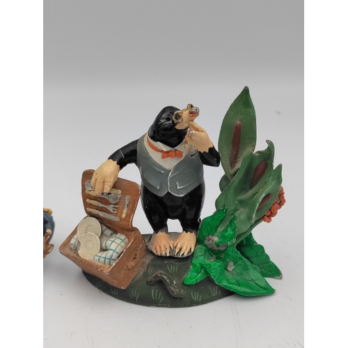 167 - A set of 4 lead The wind in the willows figures. To include Mr. Toad, Ratty, Mr. Mole & Caroling mic... 