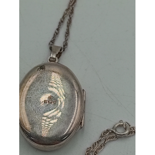 381 - A hallmarked silver locket on a stamped Sterling chain and a 1937 coronation brooch pin.