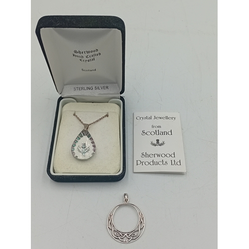 388 - A sherwood crystal jewellery thistle pendant on a silver necklace with box and paper and a stamped 9... 