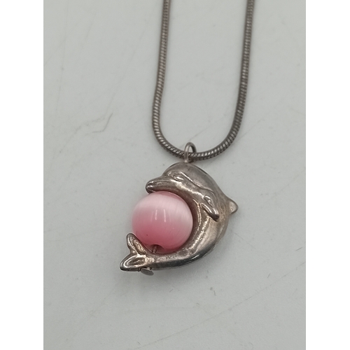389 - Two pairs of silver earrings and a Claires accessories dolphin necklace with a pink stone.