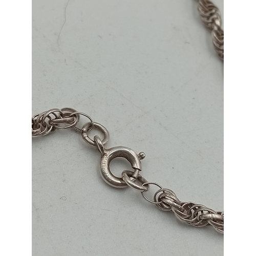 390 - A collection of three silver necklaces. To include; a stamped 925 silver necklace with a stamped sil... 