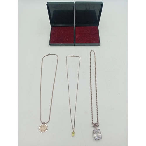 390 - A collection of three silver necklaces. To include; a stamped 925 silver necklace with a stamped sil... 