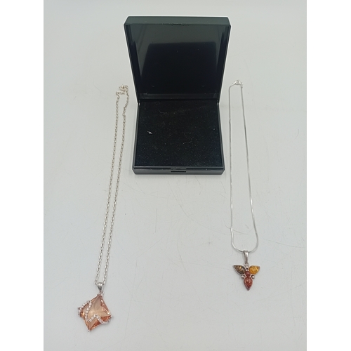 391 - Two stamped 925 silver neckslces. One has a 925 silver pendant set with amber and the other is a sta... 