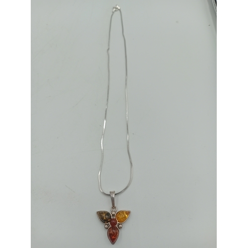 391 - Two stamped 925 silver neckslces. One has a 925 silver pendant set with amber and the other is a sta... 