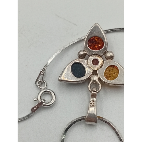 391 - Two stamped 925 silver neckslces. One has a 925 silver pendant set with amber and the other is a sta... 