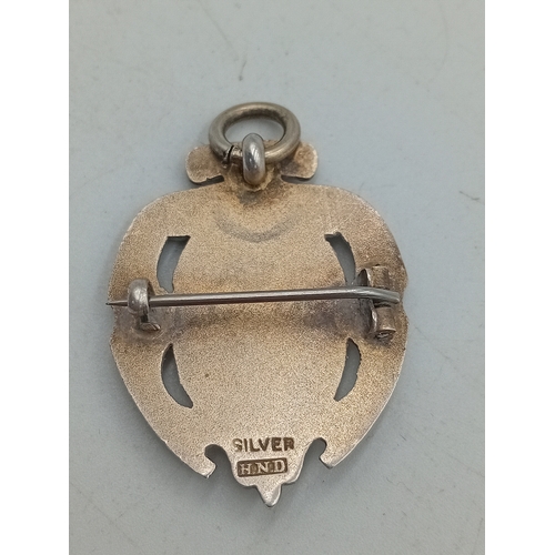 392 - A stamped 925 silver celtic style brooch and a stamped silver HND Excelsiot badge / pendant