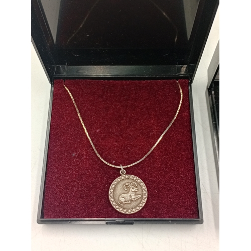 393 - Two stamped 925 silver necklaces. One has a stamped silver Aries pendant and a hallmarked 925 child ... 