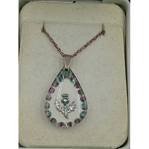 388 - A sherwood crystal jewellery thistle pendant on a silver necklace with box and paper and a stamped 9... 