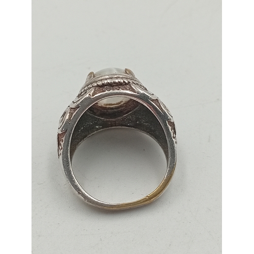 395 - A hallmarked 925 silver ring set with an orange stone and two costume rings.