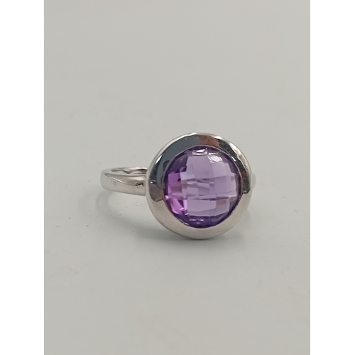 396 - A stamped 925 silver ring set with a purple stone. Size P.