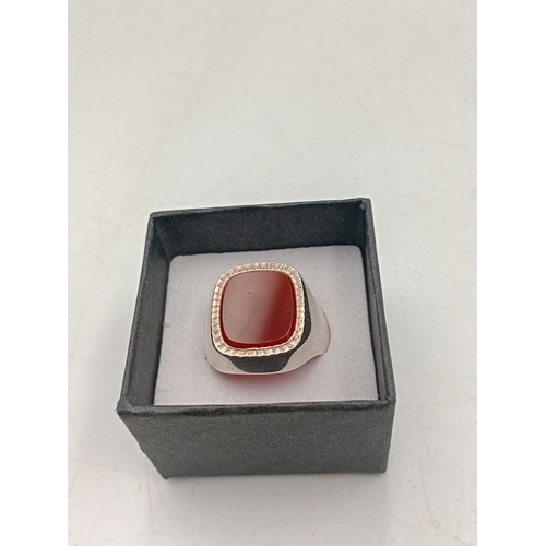 398 - A silver signet ring stamped silver with gold plating. Size S
