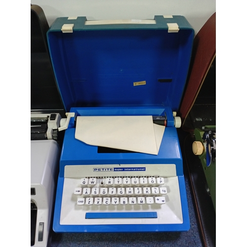 A collection of vintage portable typewriters including Typechoice de ...