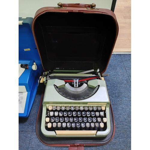 A collection of vintage portable typewriters including Typechoice de ...