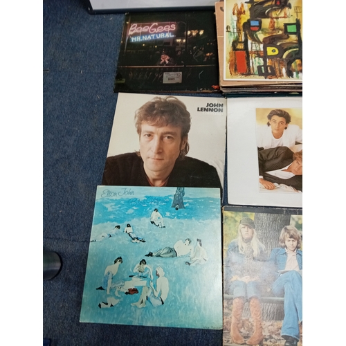 102 - A job lot of Apx 40 vinyl records of various conditions to include wham, Elton John, John Lennon Jim... 
