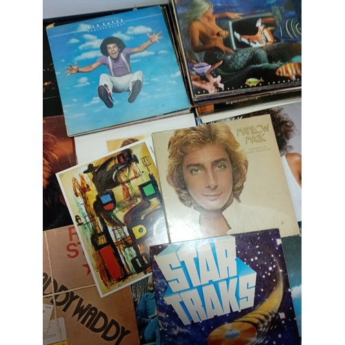 102 - A job lot of Apx 40 vinyl records of various conditions to include wham, Elton John, John Lennon Jim... 