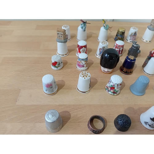 12 - a collection of thimbles: brands to include royal worcester, sterling, finsbury and one is cloisonne... 