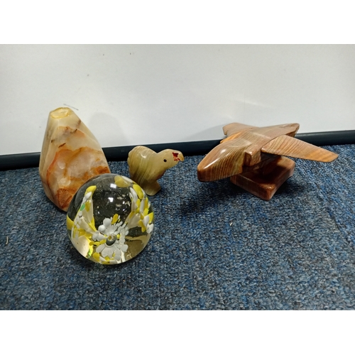 27 - A collection of hardstone ornaments including a plane, eggs and eggcups, birds, togrther with a glas... 