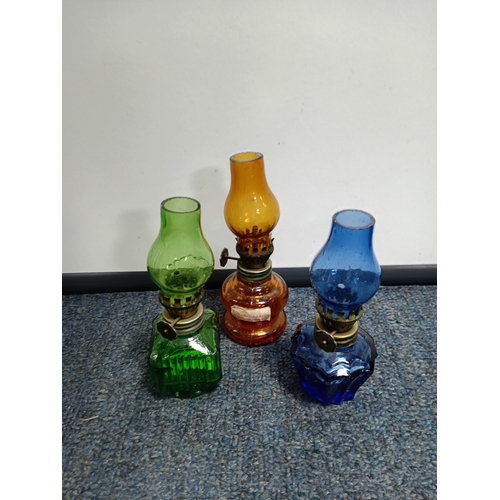 29 - Three hanging lamps together with three miniature coloured glass oil lamps