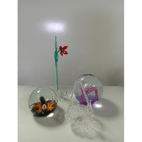 51 - A collection of glassware including a Caithness Moonflower paperweight, murano style bird of paradis... 