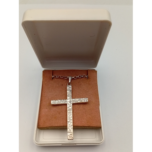 380 - A stamped silver cross pendant on a stamped 925 silver belcher chain necklace. Length 18.5