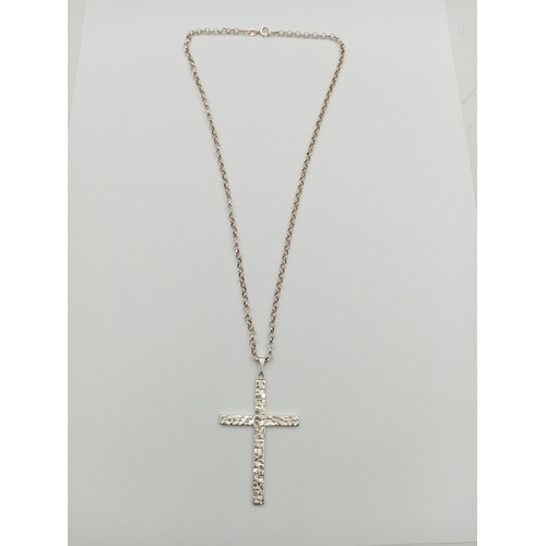380 - A stamped silver cross pendant on a stamped 925 silver belcher chain necklace. Length 18.5