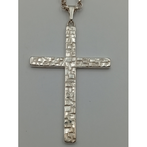 380 - A stamped silver cross pendant on a stamped 925 silver belcher chain necklace. Length 18.5