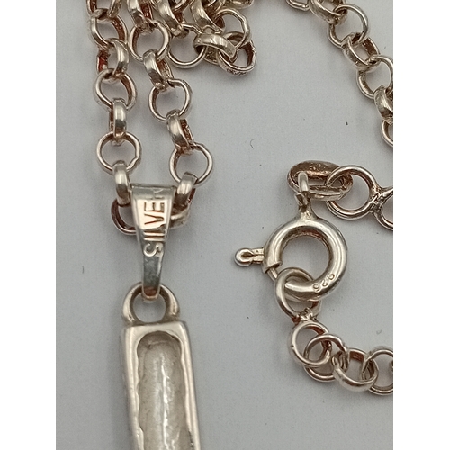 380 - A stamped silver cross pendant on a stamped 925 silver belcher chain necklace. Length 18.5