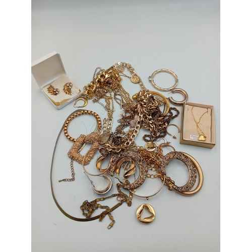 311 - A quantity of gold tone costume jewellery including a heart shaped locket necklace, chains, bracelet... 