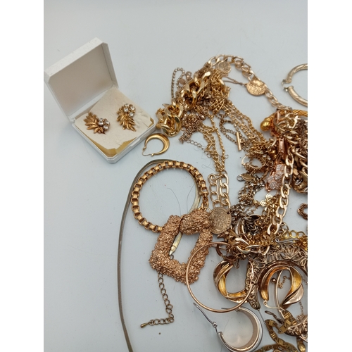 311 - A quantity of gold tone costume jewellery including a heart shaped locket necklace, chains, bracelet... 