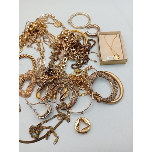 311 - A quantity of gold tone costume jewellery including a heart shaped locket necklace, chains, bracelet... 