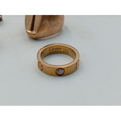 314 - A good quantity of costume rings including a Catier Love style ring, signet rings, etc