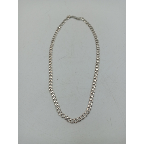 324 - A silver heavy flattened Curb link chain stamped 925, 50cm long