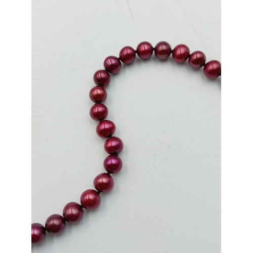 325 - An unusual red pearl necklace with clasp marked 14K, 45cm long