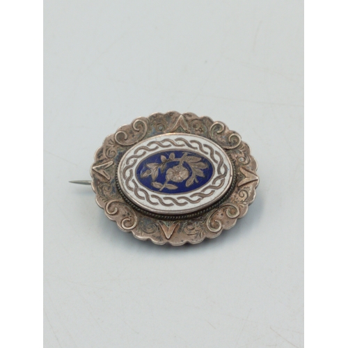 340 - An antique sterling silver and enamel floral pin brooch with counter enamel roundel