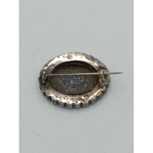 340 - An antique sterling silver and enamel floral pin brooch with counter enamel roundel