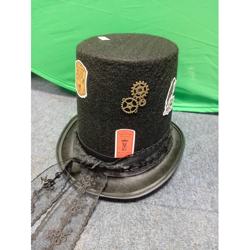 2 - A black felt steampunk top hat with removable copper toned goggles, decorative cogs, and a skull bro... 