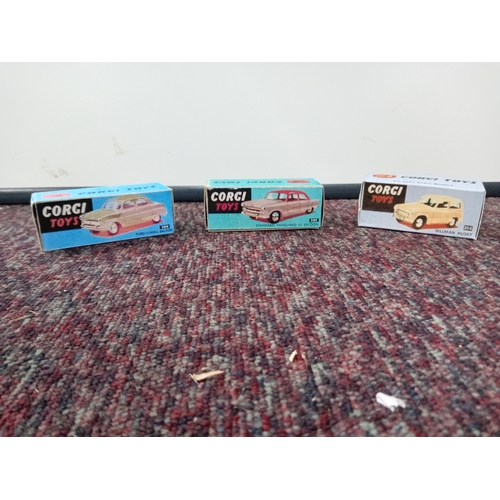 3 vintage Corgi cars with their original boxes.