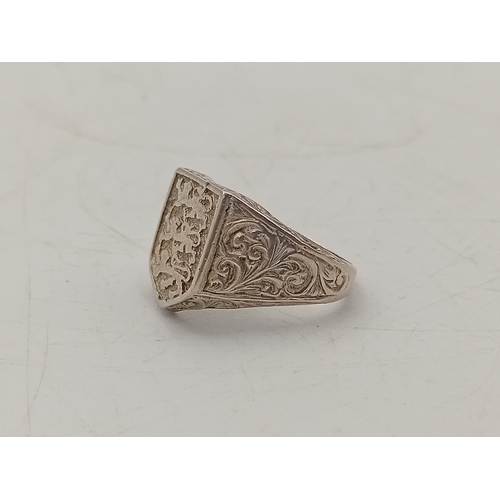 299 - A silver signet ring with Three Lions shield design, stamped SILVER
