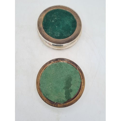 258 - 2 Sterling Silver & Oak Bottle Coasters. One is engraved T.B.D. Each measures 12.5cm in diameter by ... 