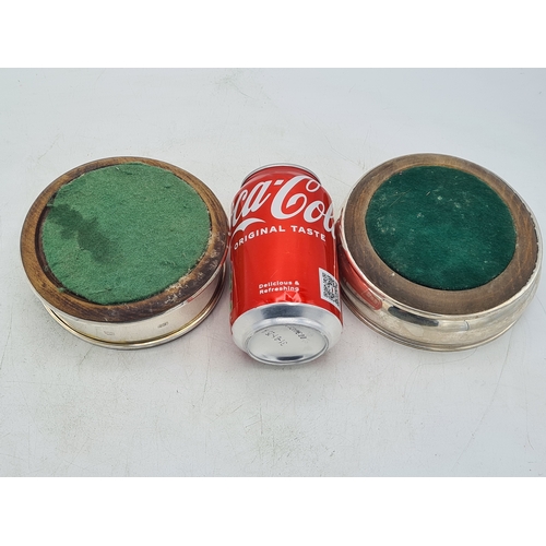 258 - 2 Sterling Silver & Oak Bottle Coasters. One is engraved T.B.D. Each measures 12.5cm in diameter by ... 
