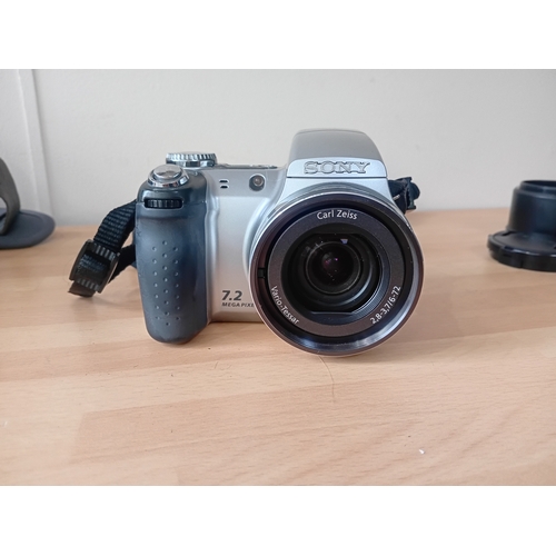 102 -  A Sony Cyber-shot DSC-H5 digital camera with a carrying case by laystor professional,and the cover ... 