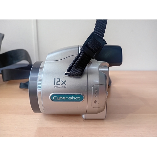 102 -  A Sony Cyber-shot DSC-H5 digital camera with a carrying case by laystor professional,and the cover ... 