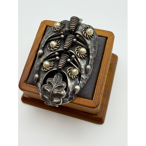 17 - A tested 500 silver handmade brooch with flux pearls and base metal clip.