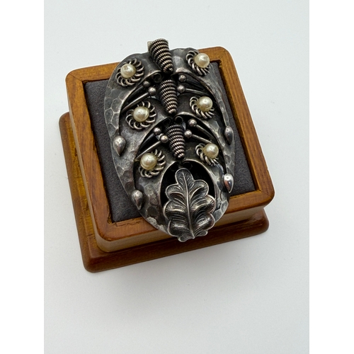 17 - A tested 500 silver handmade brooch with flux pearls and base metal clip.
