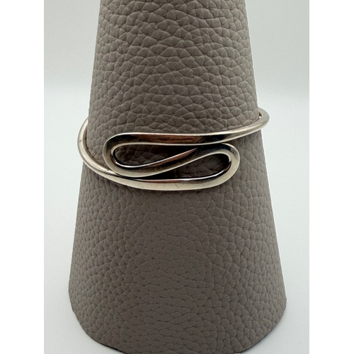 65 - A stamped 925 silver bangle in a modern style.