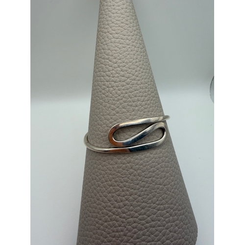 65 - A stamped 925 silver bangle in a modern style.