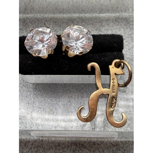 66 - A set of 9ct gold studs with a hallmarked 375 9ct gold “K” pendant.