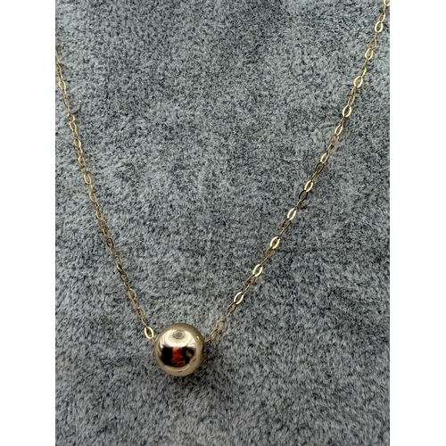70 - A stamped 375 9ct gold necklace with a ball.