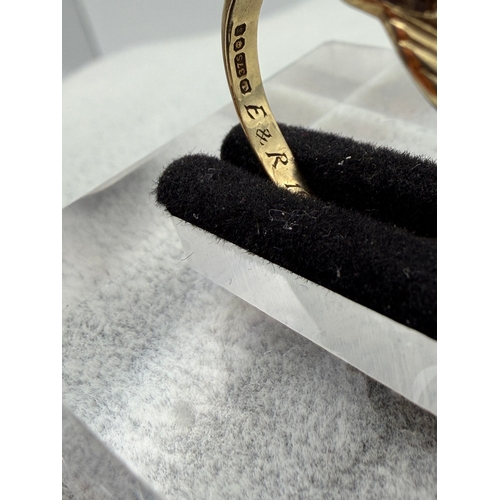 72 - A hallmarked 375 9ct gold Claddagh ring with a garnet surrounded with diamonds. Size P.